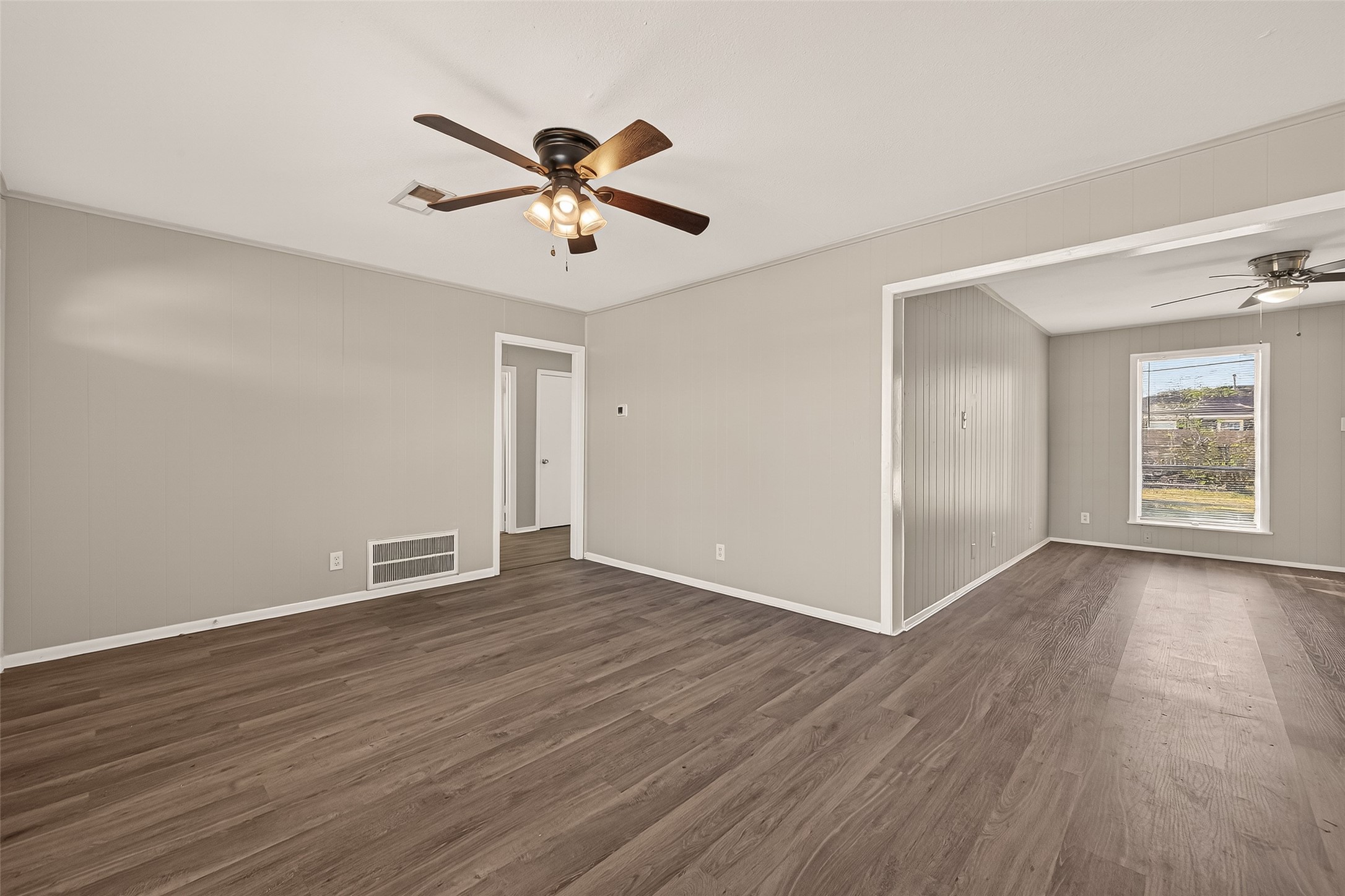 3102 Hays Street Pasadena, TX 77503 - Photo 9 of 25 a view of an empty room with wooden floor and a window