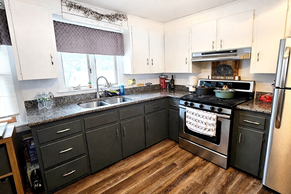 5 William Street Acushnet, MA 02743 - Photo 4 of 20 a kitchen with stainless steel appliances granite countertop a sink stove and cabinets