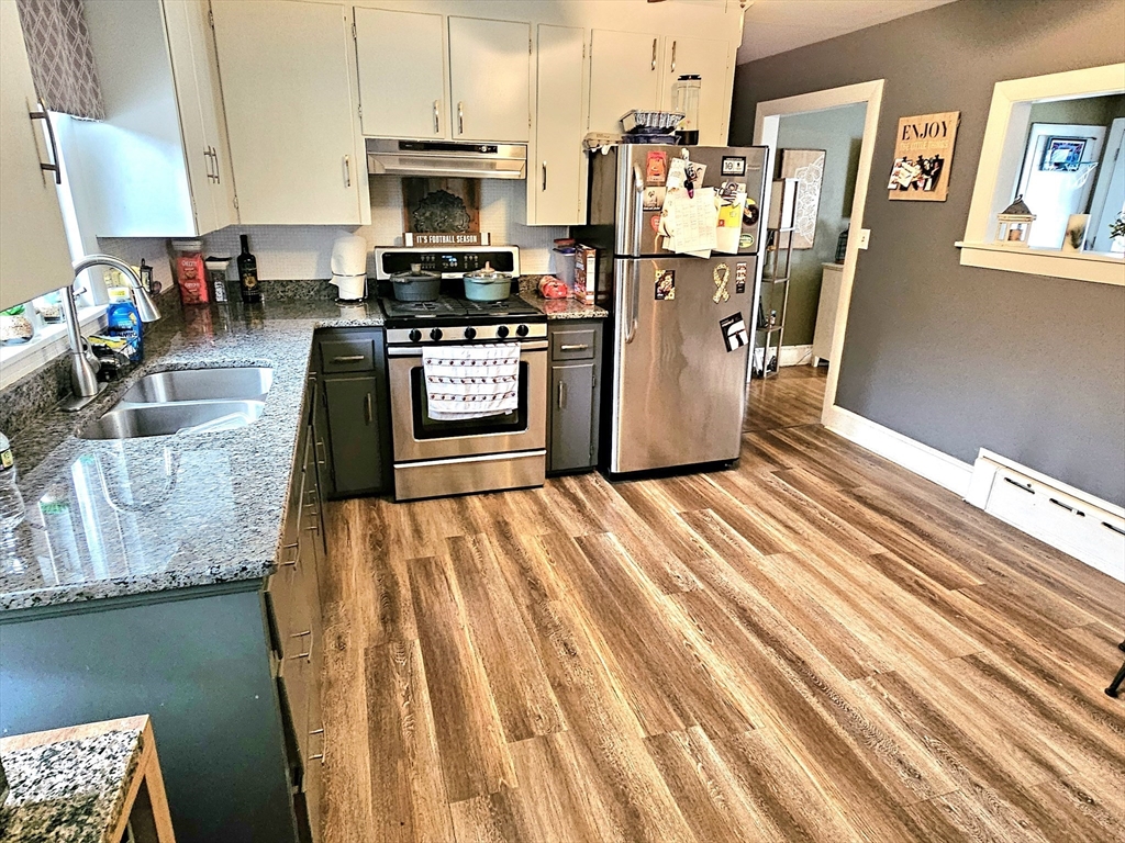 5 William Street Acushnet, MA 02743 - Photo 5 of 20 a kitchen with stainless steel appliances kitchen island granite countertop a refrigerator stove oven and a sink with dishwasher
