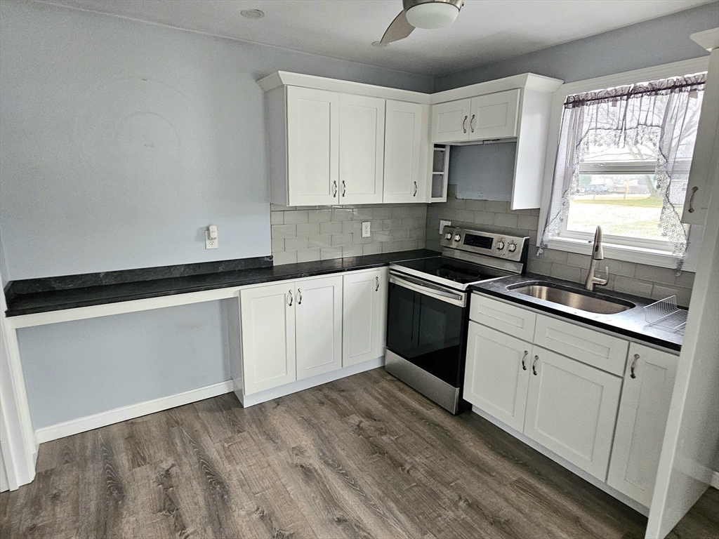 5 William Street Acushnet, MA 02743 - Photo 10 of 20 a kitchen with granite countertop white cabinets and white appliances