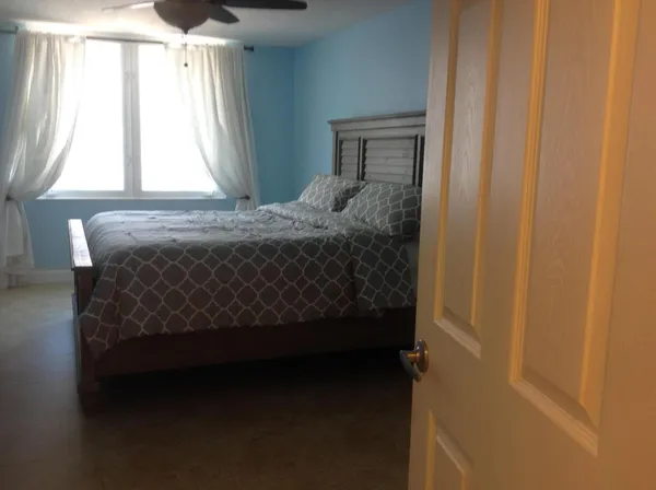 a bed sitting in a bedroom next to a window