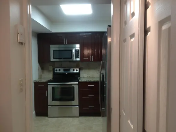 a kitchen with a sink and a granite counter tops