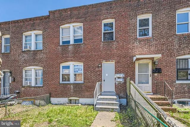 a front view of a house with outdoor seating