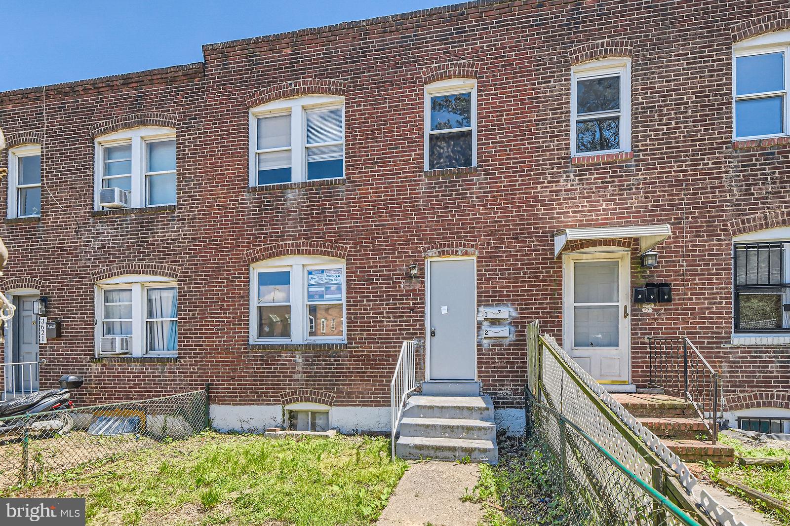 a front view of a house with outdoor seating