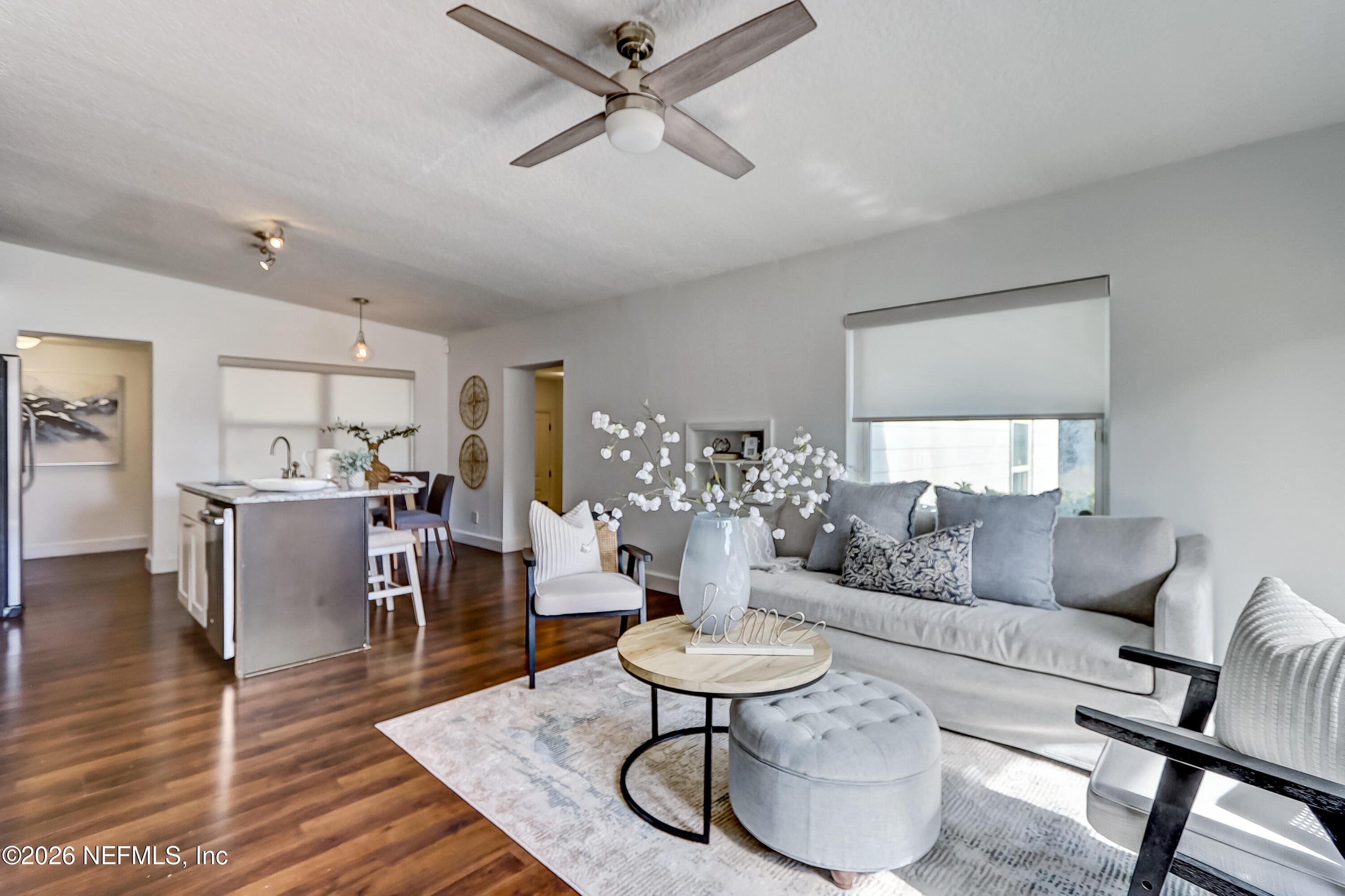 a living room with furniture and a wooden floor