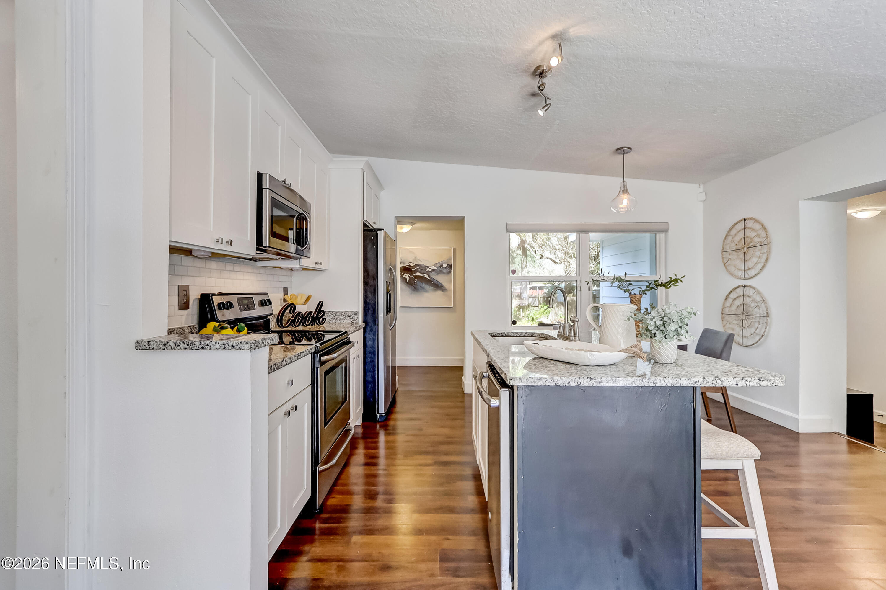 2477 Community Road Jacksonville, FL 32207 - Photo 11 of 33 a kitchen with stainless steel appliances granite countertop a stove oven and a refrigerator
