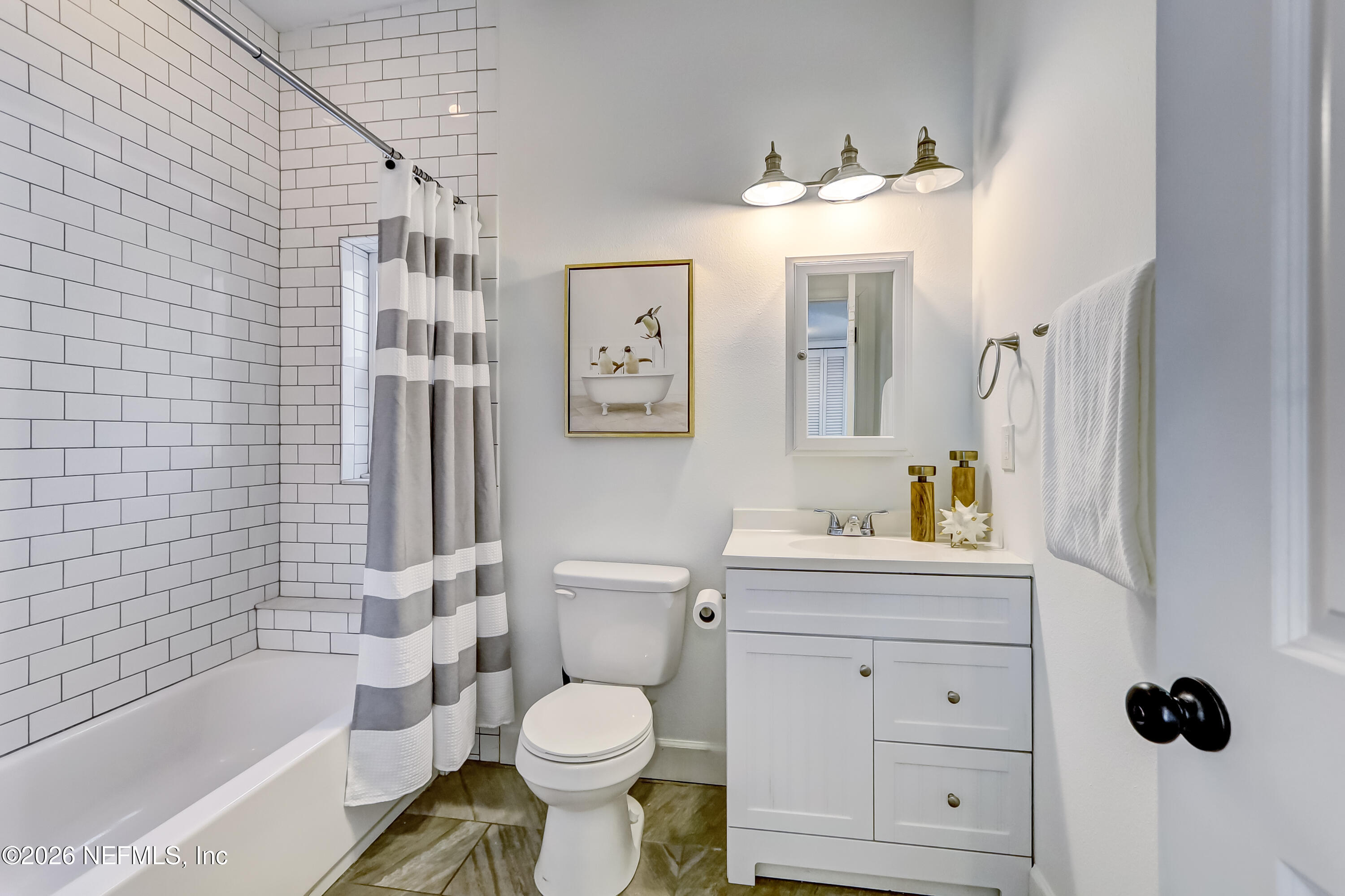 2477 Community Road Jacksonville, FL 32207 - Photo 13 of 33 a bathroom with a sink toilet a shower and bathtub