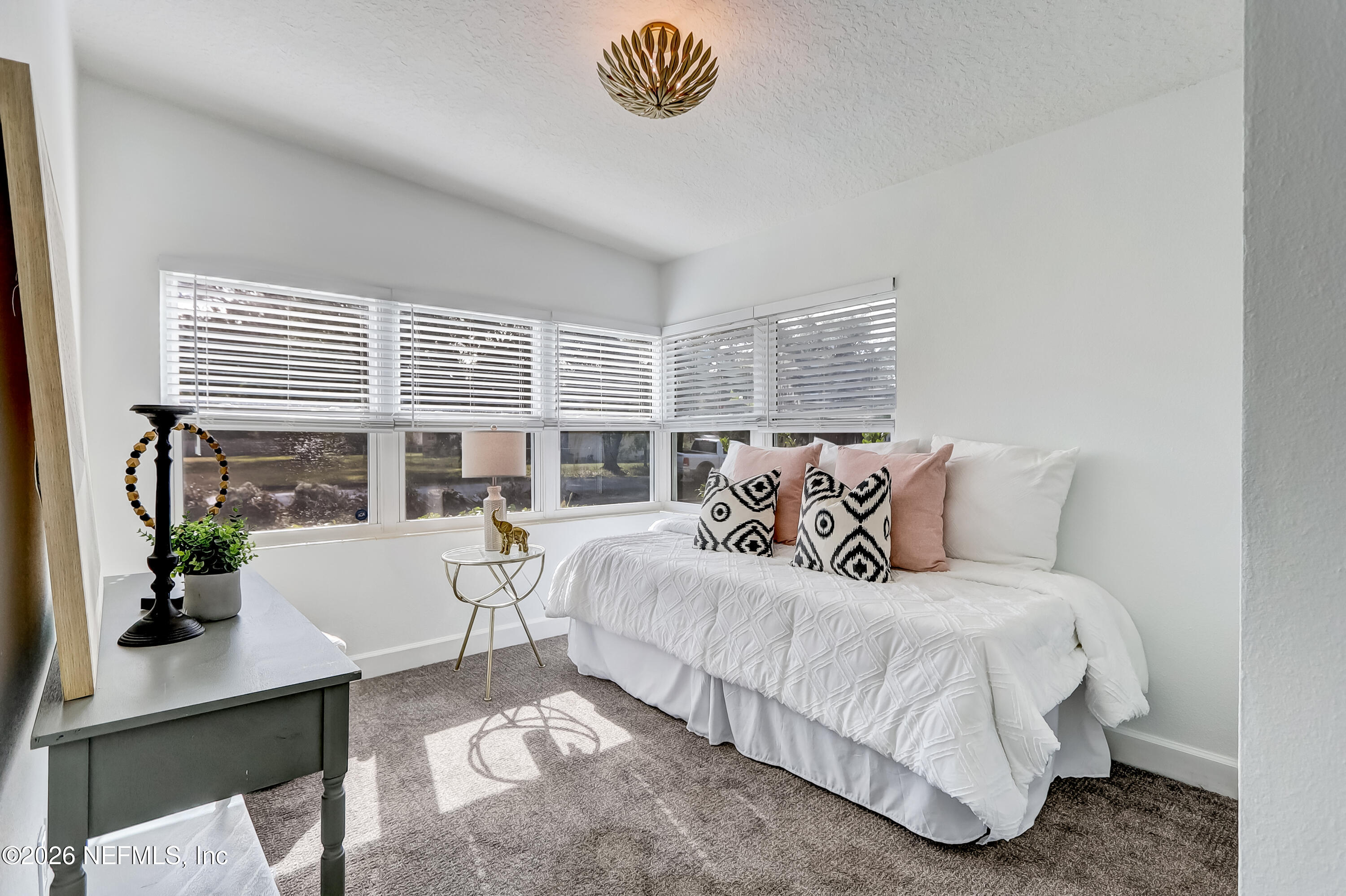 2477 Community Road Jacksonville, FL 32207 - Photo 16 of 33 a bedroom with a large bed and a table