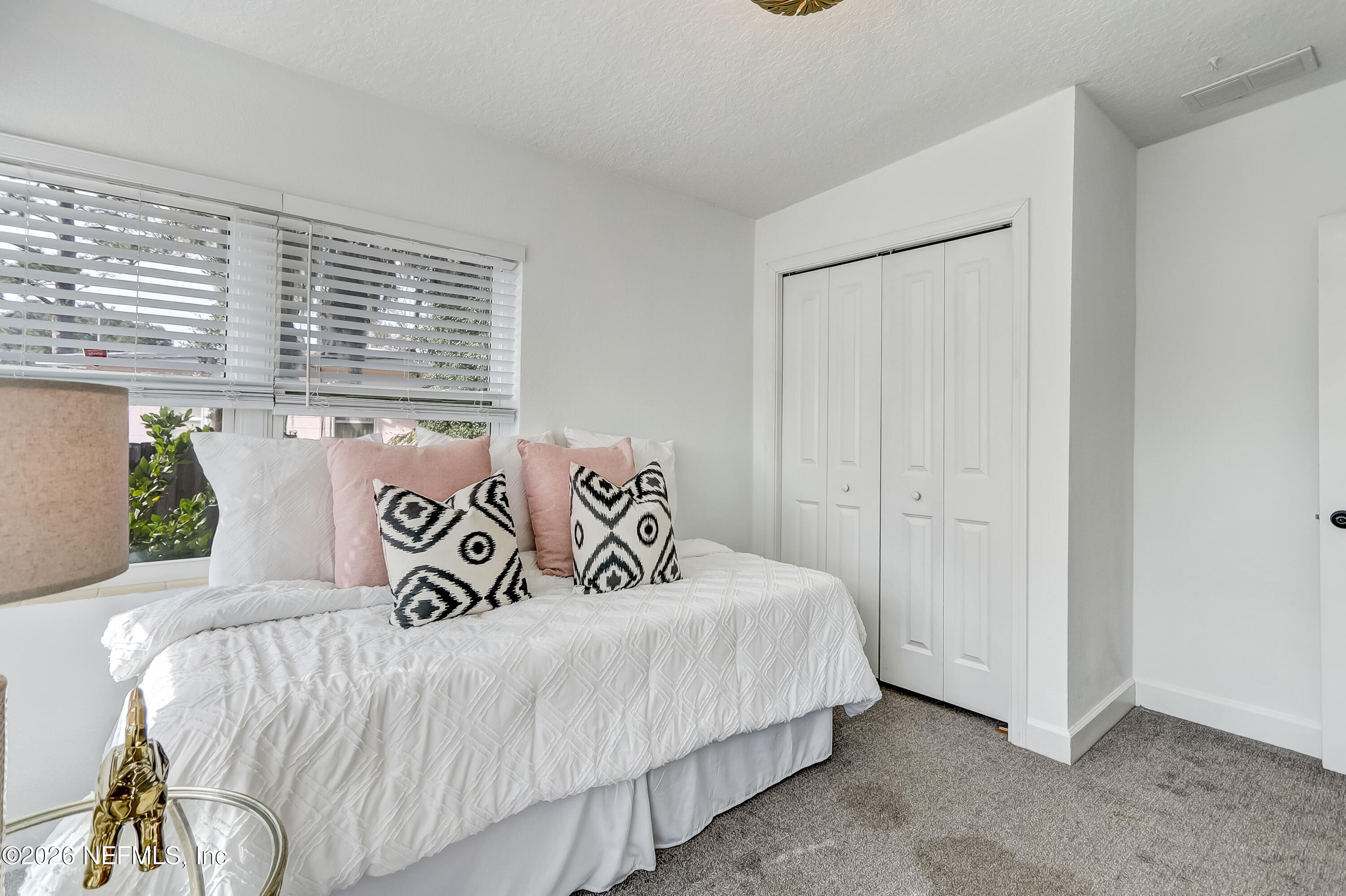 2477 Community Road Jacksonville, FL 32207 - Photo 17 of 33 a bedroom with a bed and a window