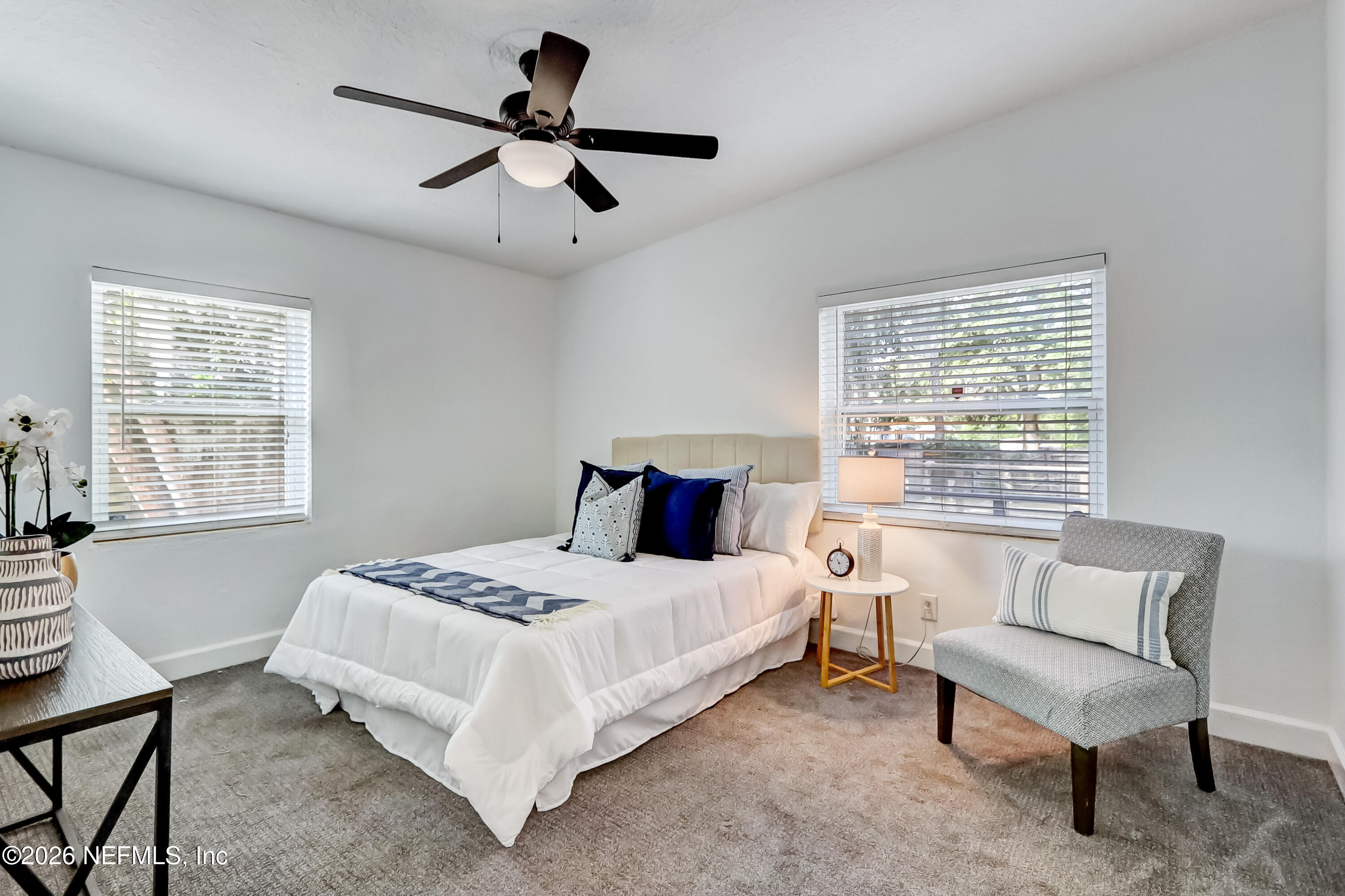 2477 Community Road Jacksonville, FL 32207 - Photo 18 of 33 a bedroom with a bed a couch and a large window