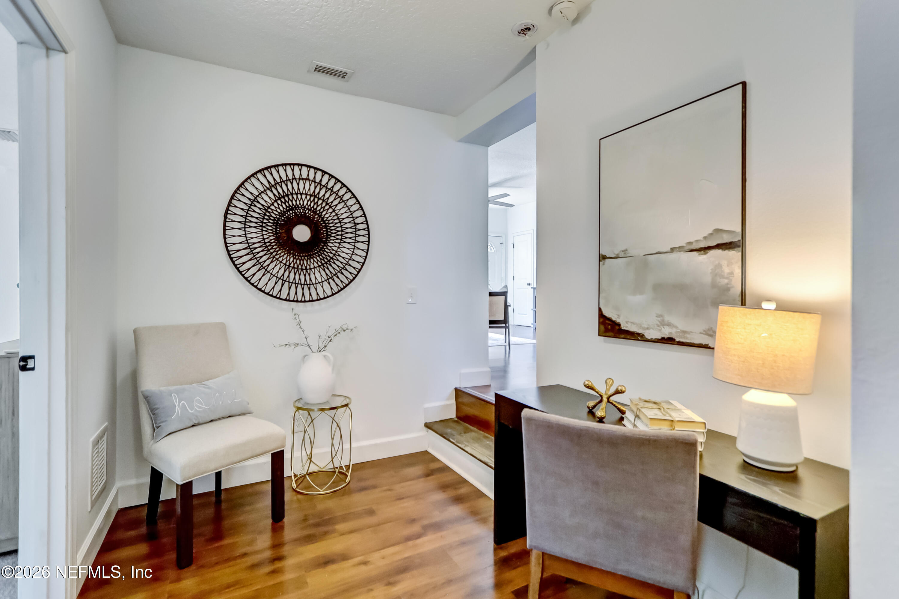 2477 Community Road Jacksonville, FL 32207 - Photo 20 of 33 a living room with furniture and a wooden floor