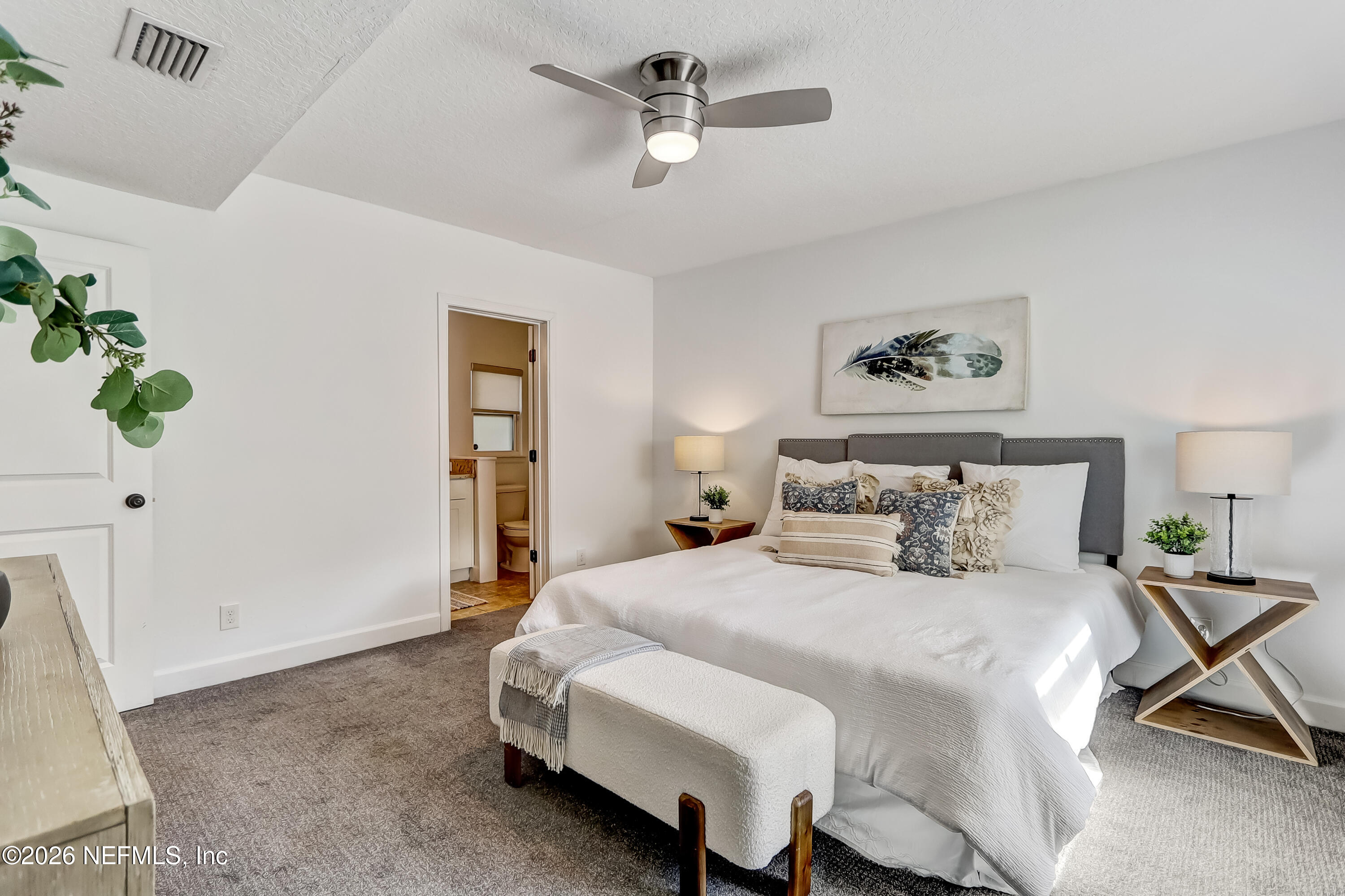 2477 Community Road Jacksonville, FL 32207 - Photo 22 of 33 a bedroom with a bed dresser and a window