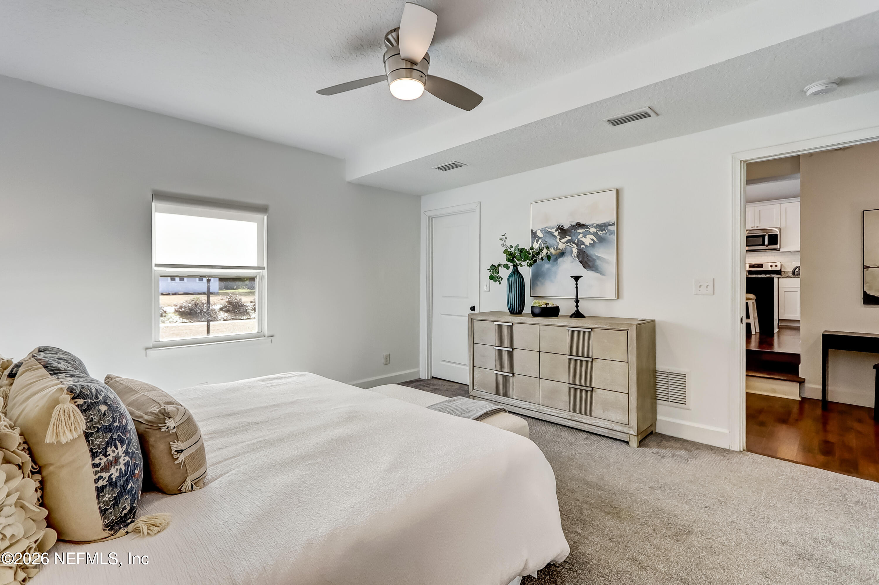 2477 Community Road Jacksonville, FL 32207 - Photo 23 of 33 a bedroom with a bed and cabinets