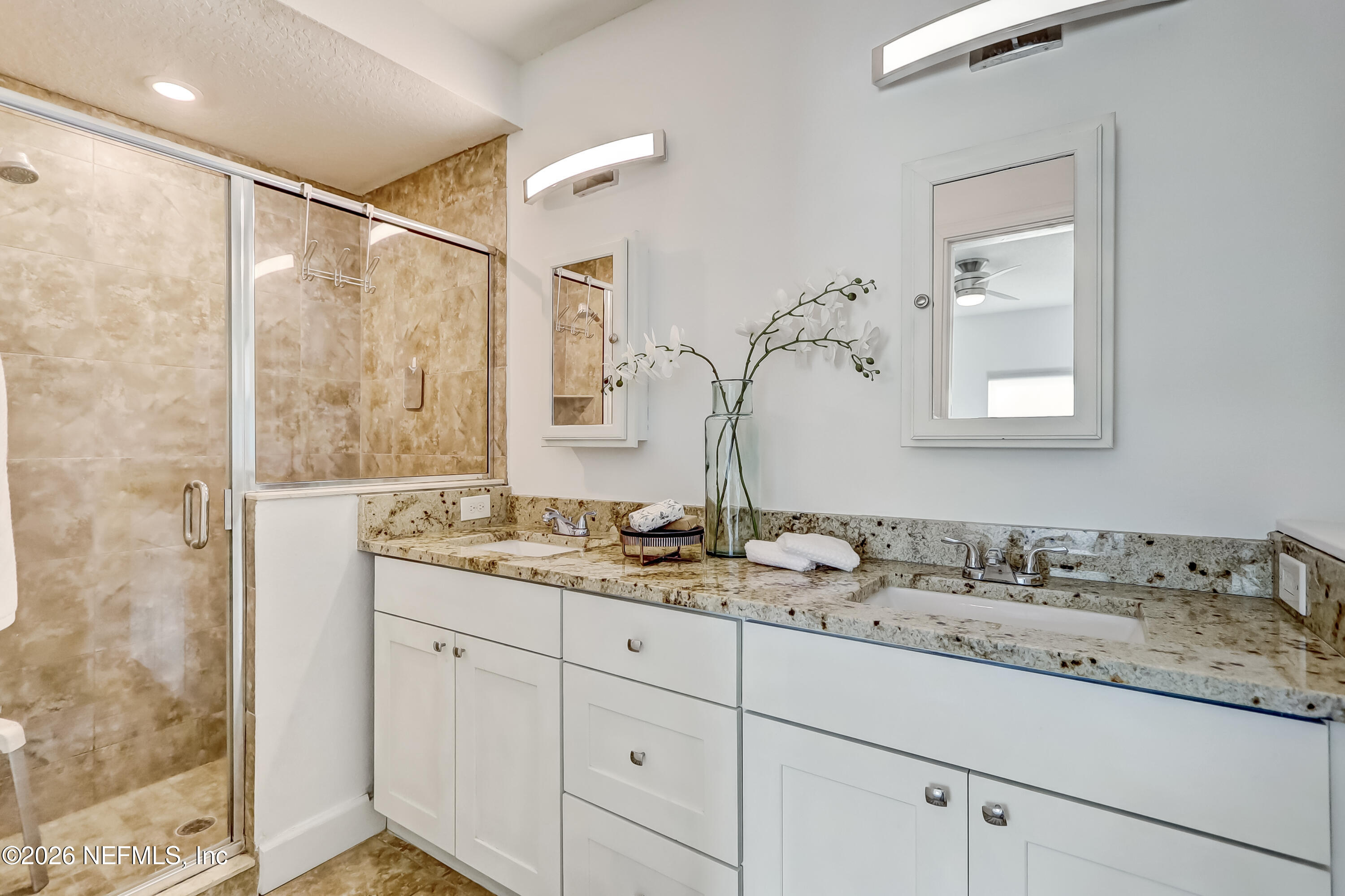2477 Community Road Jacksonville, FL 32207 - Photo 24 of 33 a bathroom with a double vanity sink and mirror