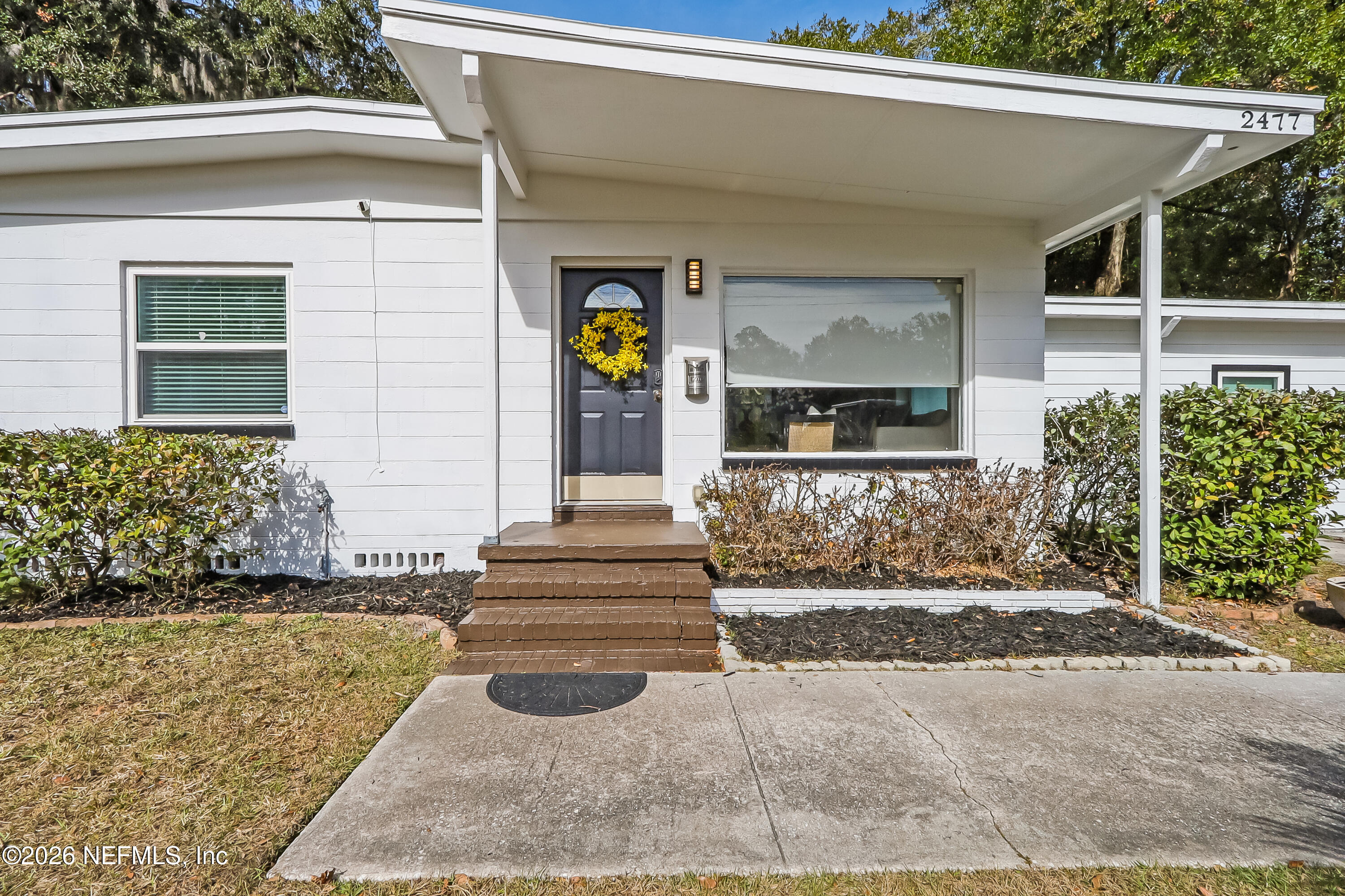 2477 Community Road Jacksonville, FL 32207 - Photo 28 of 33 a front view of a house with a yard