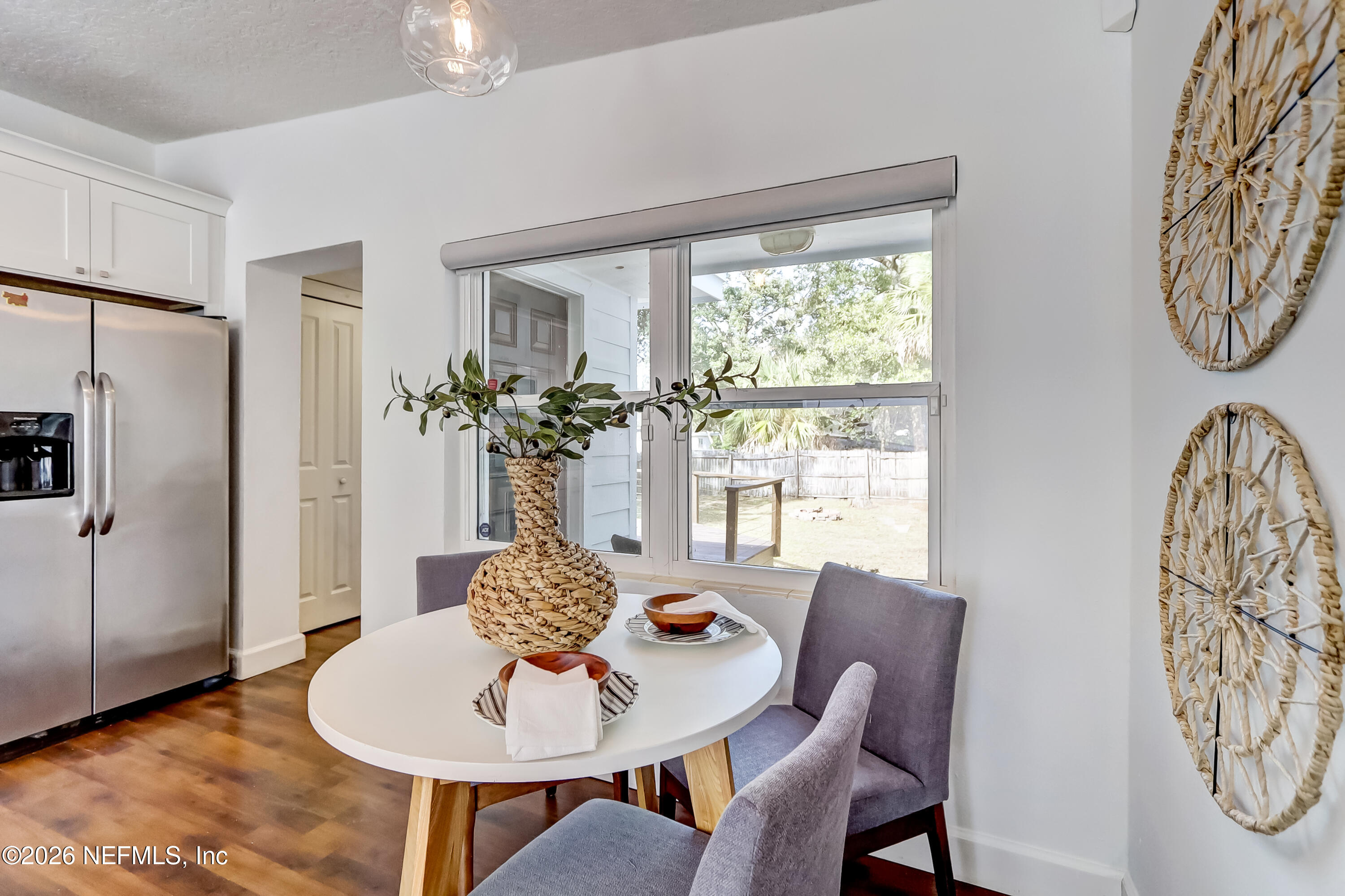2477 Community Road Jacksonville, FL 32207 - Photo 5 of 33 a dining room with furniture a potted plant and a chandelier