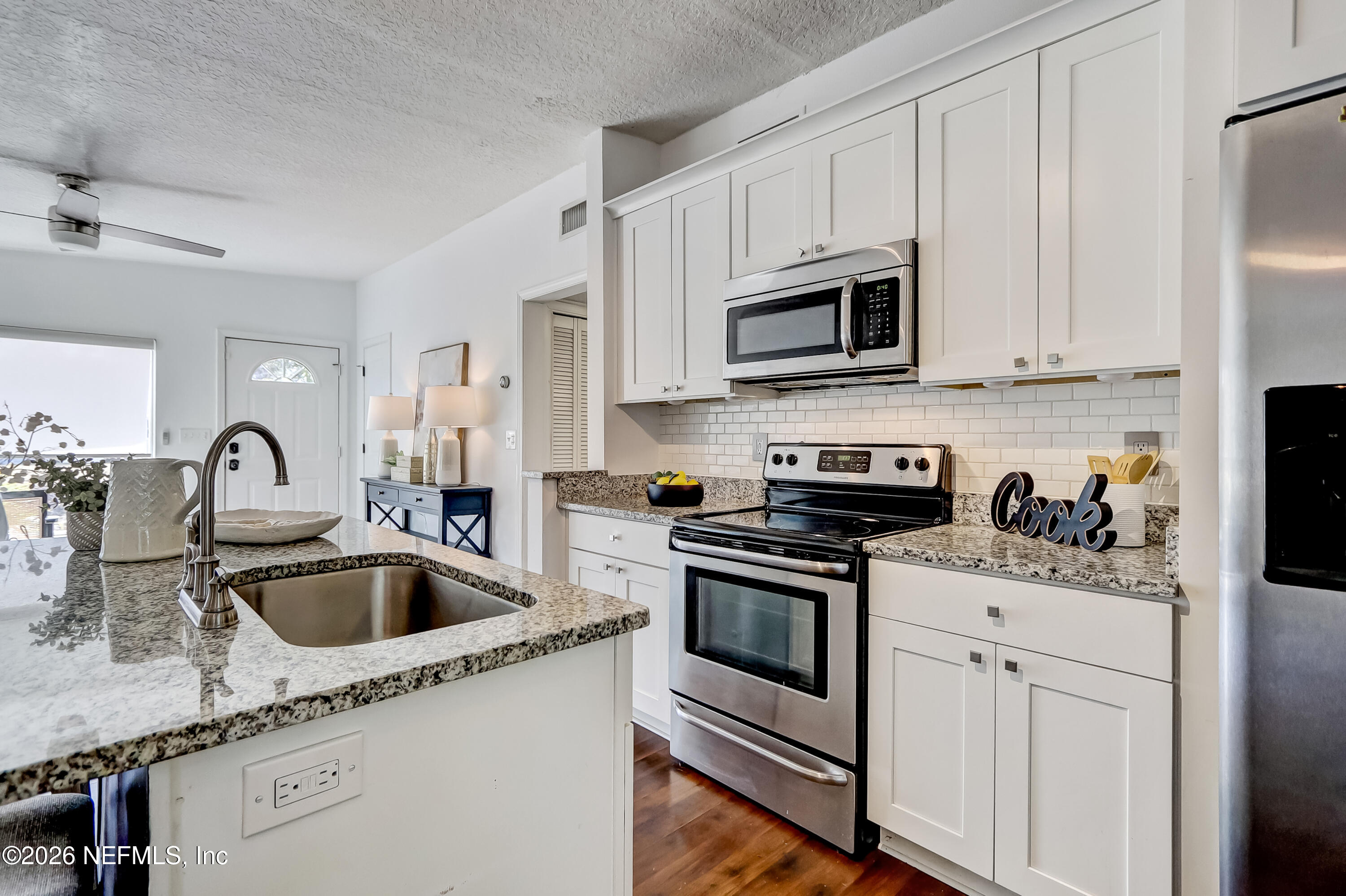 2477 Community Road Jacksonville, FL 32207 - Photo 7 of 33 a kitchen with stainless steel appliances granite countertop a sink a stove and cabinets