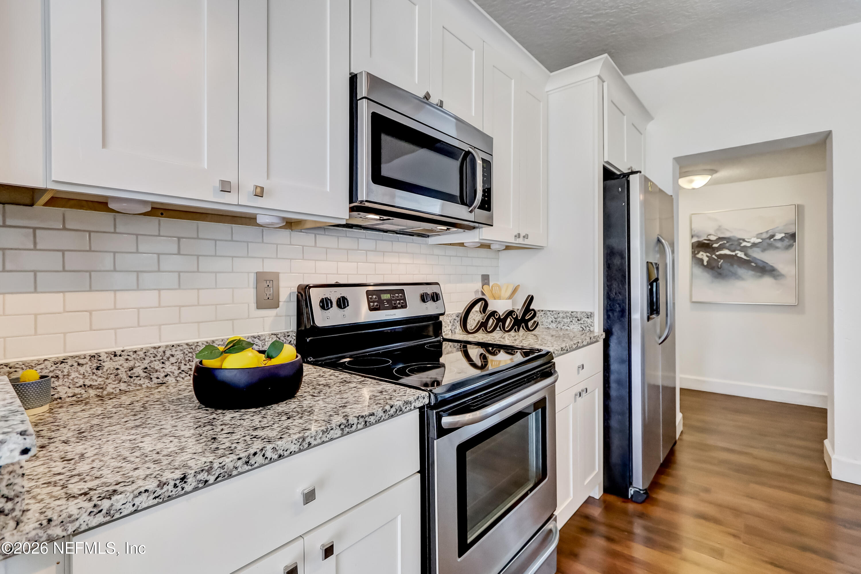 2477 Community Road Jacksonville, FL 32207 - Photo 10 of 33 a kitchen with a stove and a microwave