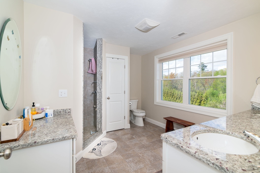 51 Tamarack Road Dracut, MA 01826 - Photo 17 of 39 a bathroom with a granite countertop sink and a mirror