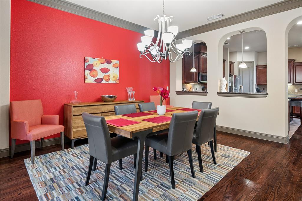 835 Rockingham Drive Irving, TX 75063 - Photo 4 of 27 a dining room with furniture a chandelier and wooden floor