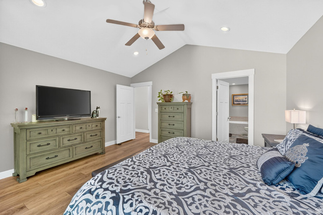 7872 Farm House Lane Midvale, UT 84047 - Photo 18 of 39 Vaulted ceiling primary bedroom featuring wood-finish flooring, recessed lighting, and a ceiling fan