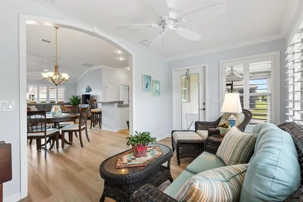 a living room with furniture kitchen and a chandelier