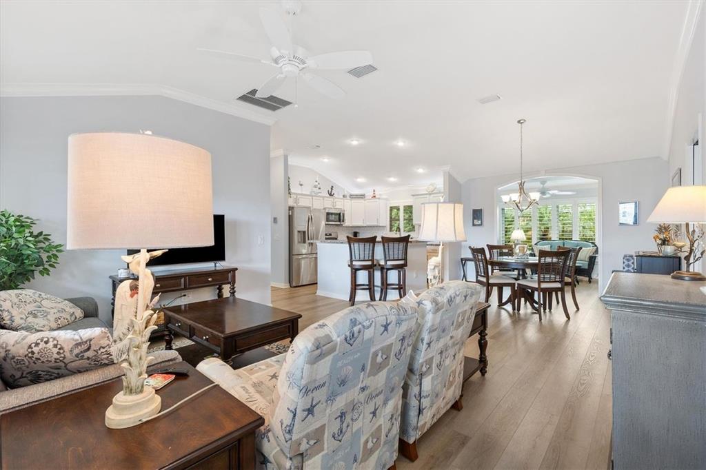 3394 Ridgewood Path The Villages, FL 32163 - Photo 14 of 30 a living room with furniture kitchen view and a chandelier