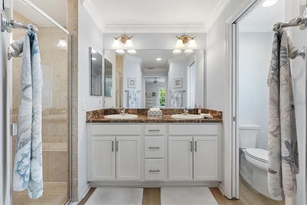 a bathroom with a double vanity sink and a mirror