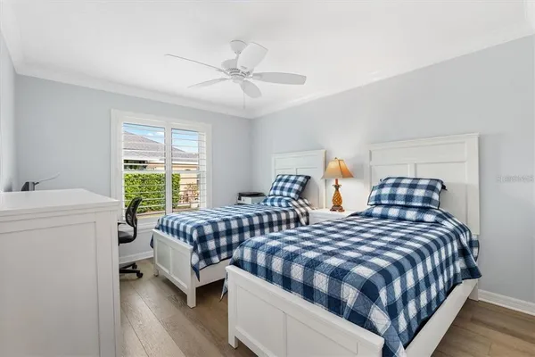a bedroom with two beds and a chandelier