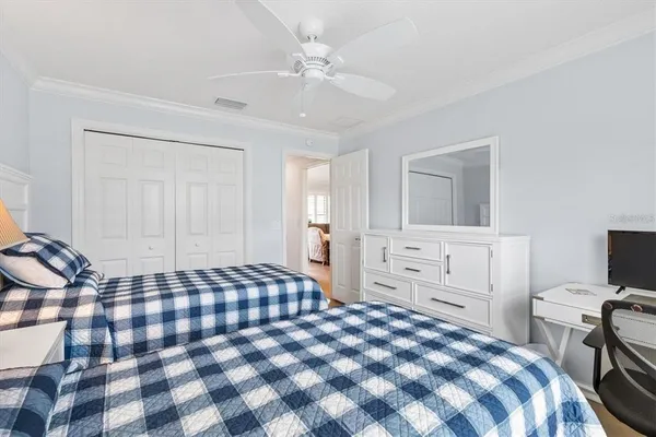a bedroom with a bed and a chandelier