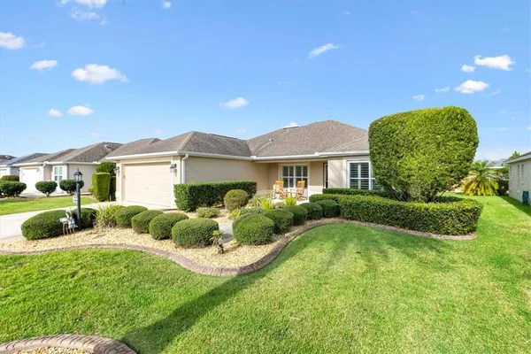 a front view of a house with garden