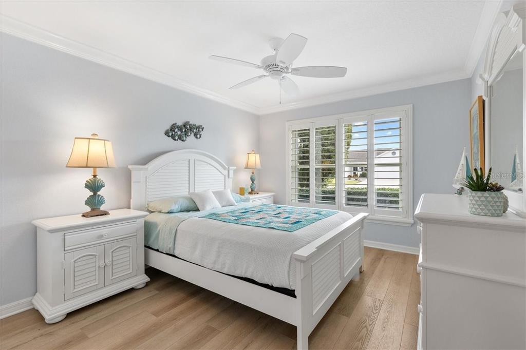3394 Ridgewood Path The Villages, FL 32163 - Photo 21 of 30 a bedroom with a bed and a chandelier
