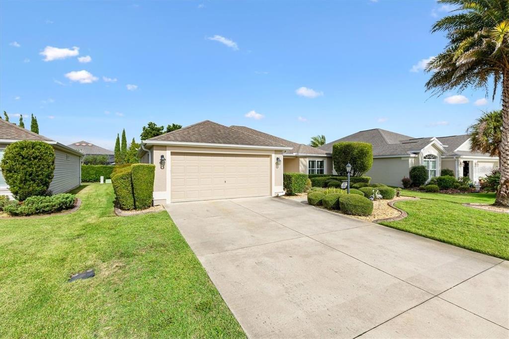 3394 Ridgewood Path The Villages, FL 32163 - Photo 28 of 30 a view of a house with a yard and potted plants