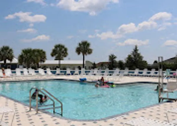 a view of a swimming pool and lounge chair