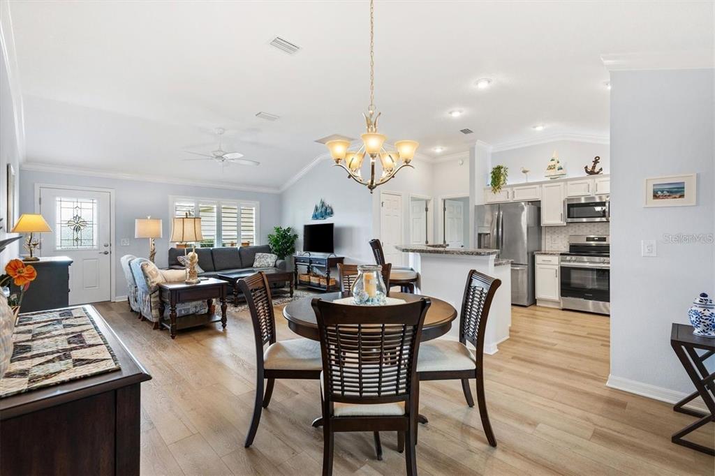 3394 Ridgewood Path The Villages, FL 32163 - Photo 4 of 30 a view of a dining room with furniture and wooden floor