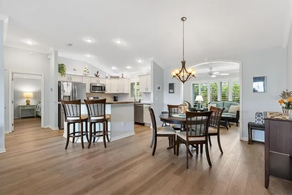 a dining room with furniture window and wooden floor
