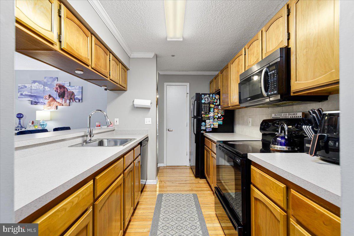 14018 Valleyfield Drive, Unit 8 Silver Spring, MD 20906 - Photo 12 of 20 a kitchen with stainless steel appliances granite countertop lots of counter top space and wooden floor