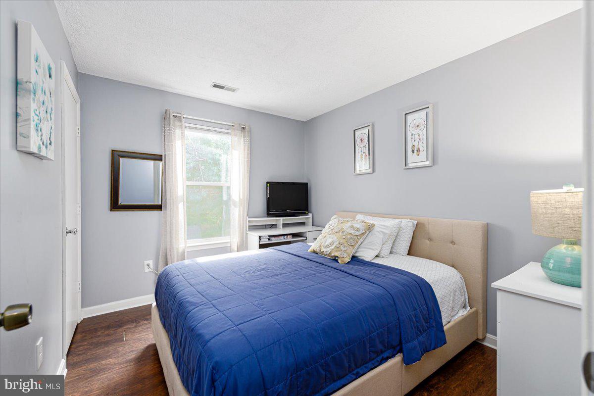 14018 Valleyfield Drive, Unit 8 Silver Spring, MD 20906 - Photo 15 of 20 a bedroom with a bed and a flat screen tv