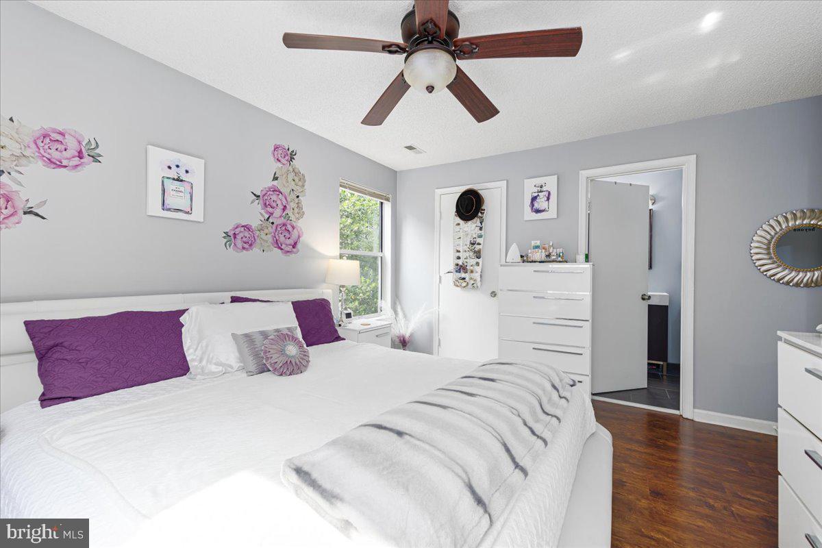 14018 Valleyfield Drive, Unit 8 Silver Spring, MD 20906 - Photo 18 of 20 a bedroom with bed and a chandelier