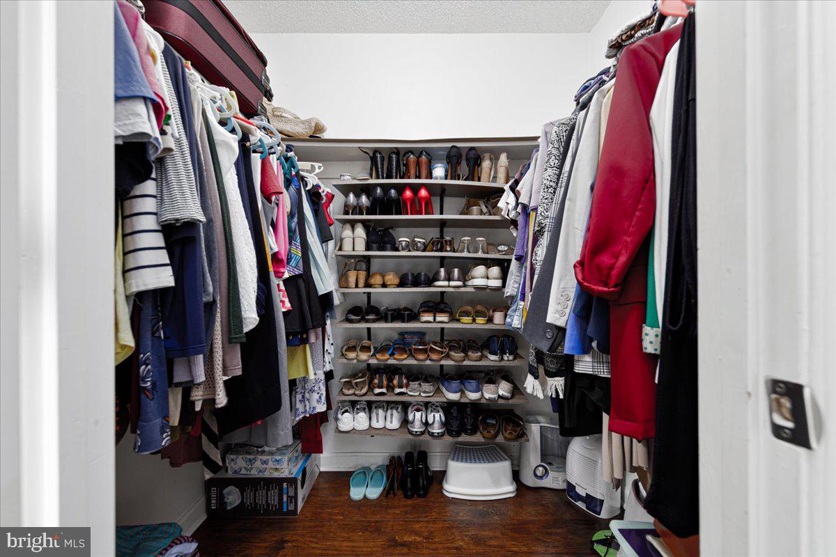 14018 Valleyfield Drive, Unit 8 Silver Spring, MD 20906 - Photo 19 of 20 a view of walk in closet with clothes and shoes