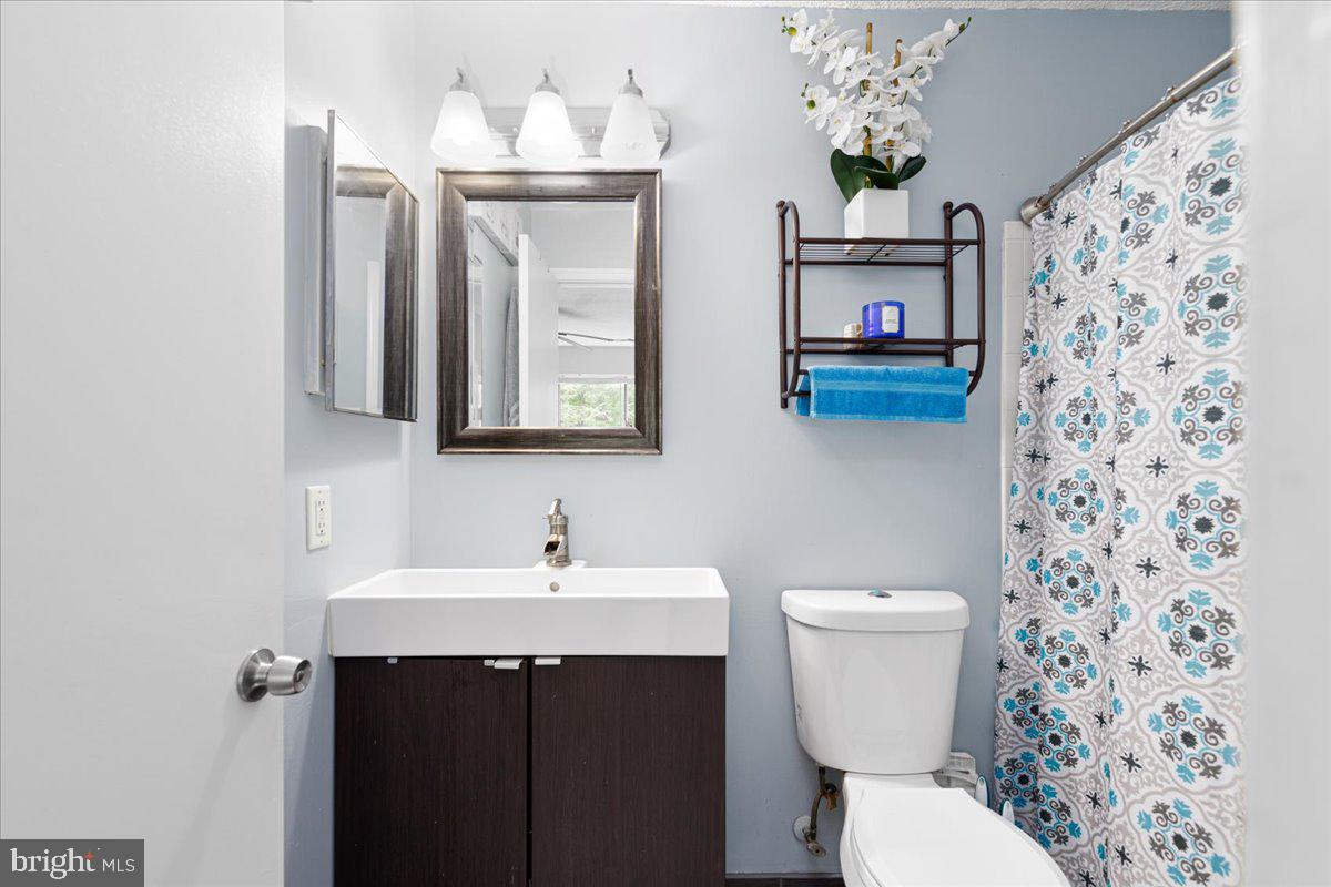 14018 Valleyfield Drive, Unit 8 Silver Spring, MD 20906 - Photo 20 of 20 a bathroom with a toilet sink and mirror