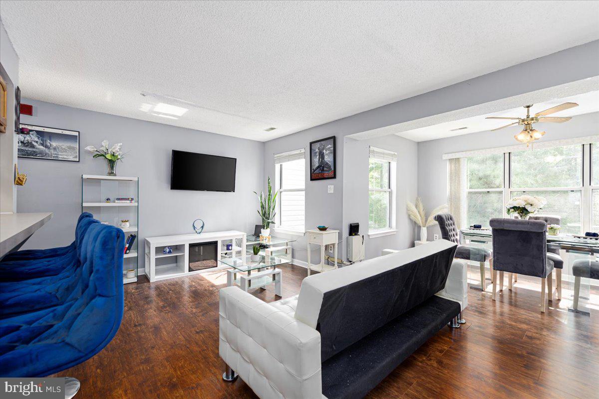 14018 Valleyfield Drive, Unit 8 Silver Spring, MD 20906 - Photo 5 of 20 a living room with furniture a flat screen tv and a large window