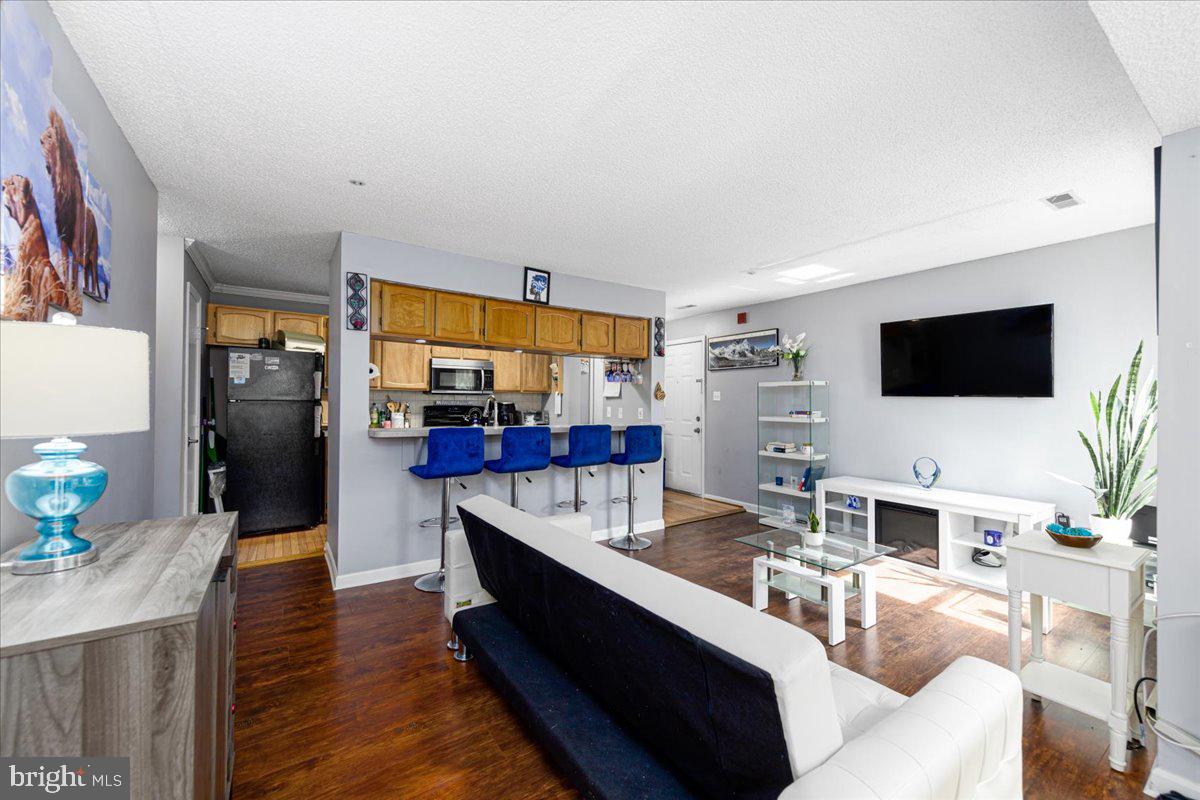 14018 Valleyfield Drive, Unit 8 Silver Spring, MD 20906 - Photo 6 of 20 a living room with fireplace furniture and a flat screen tv