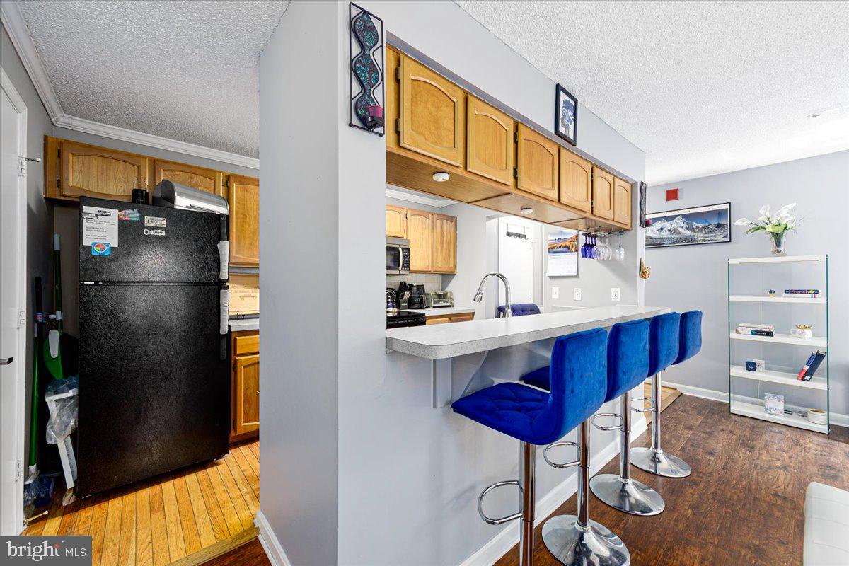 14018 Valleyfield Drive, Unit 8 Silver Spring, MD 20906 - Photo 10 of 20 a kitchen with stainless steel appliances granite countertop a refrigerator and a stove
