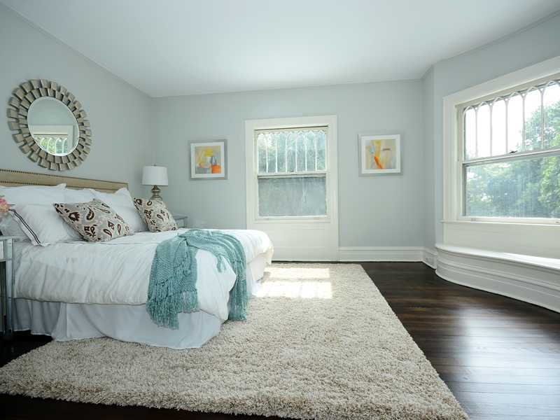 66 Pear Tree Point Road Darien, CT 06820 - Photo 16 of 25 a bedroom with a bed and wooden floor