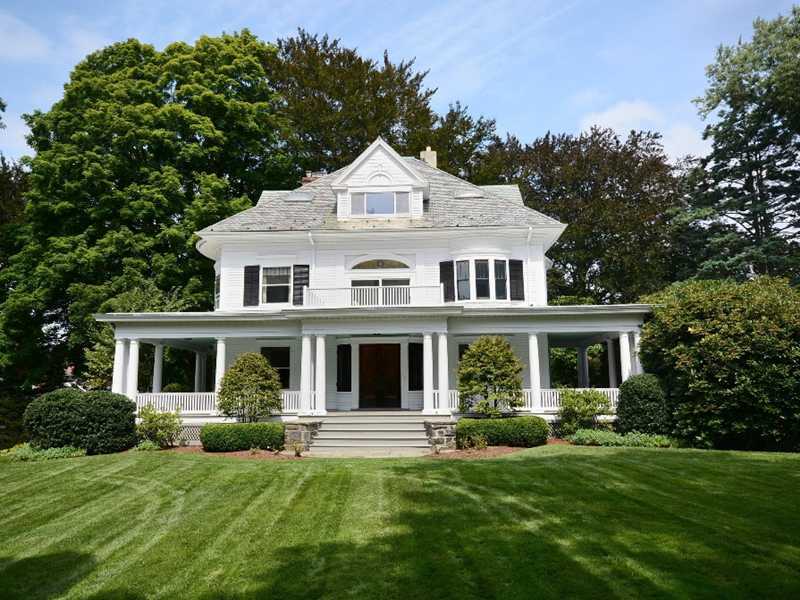 66 Pear Tree Point Road Darien, CT 06820 - Photo 2 of 25 a front view of a house with a garden