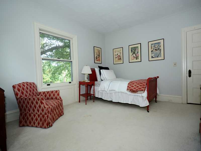66 Pear Tree Point Road Darien, CT 06820 - Photo 22 of 25 a bedroom with a bed and a couch