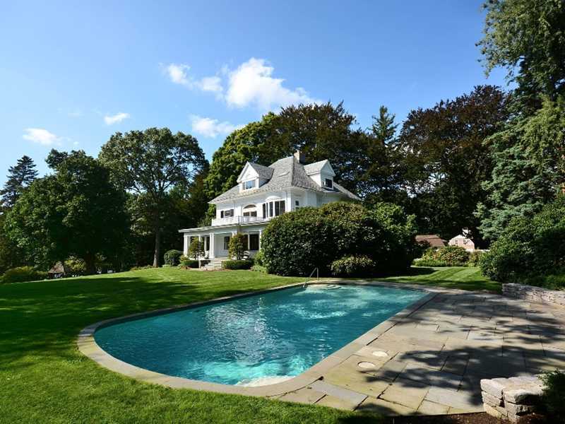 66 Pear Tree Point Road Darien, CT 06820 - Photo 25 of 25 a view of a house with a swimming pool and a yard