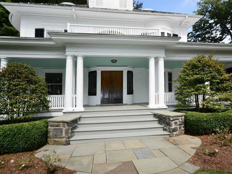 66 Pear Tree Point Road Darien, CT 06820 - Photo 5 of 25 a view of a building with a bench in front of house
