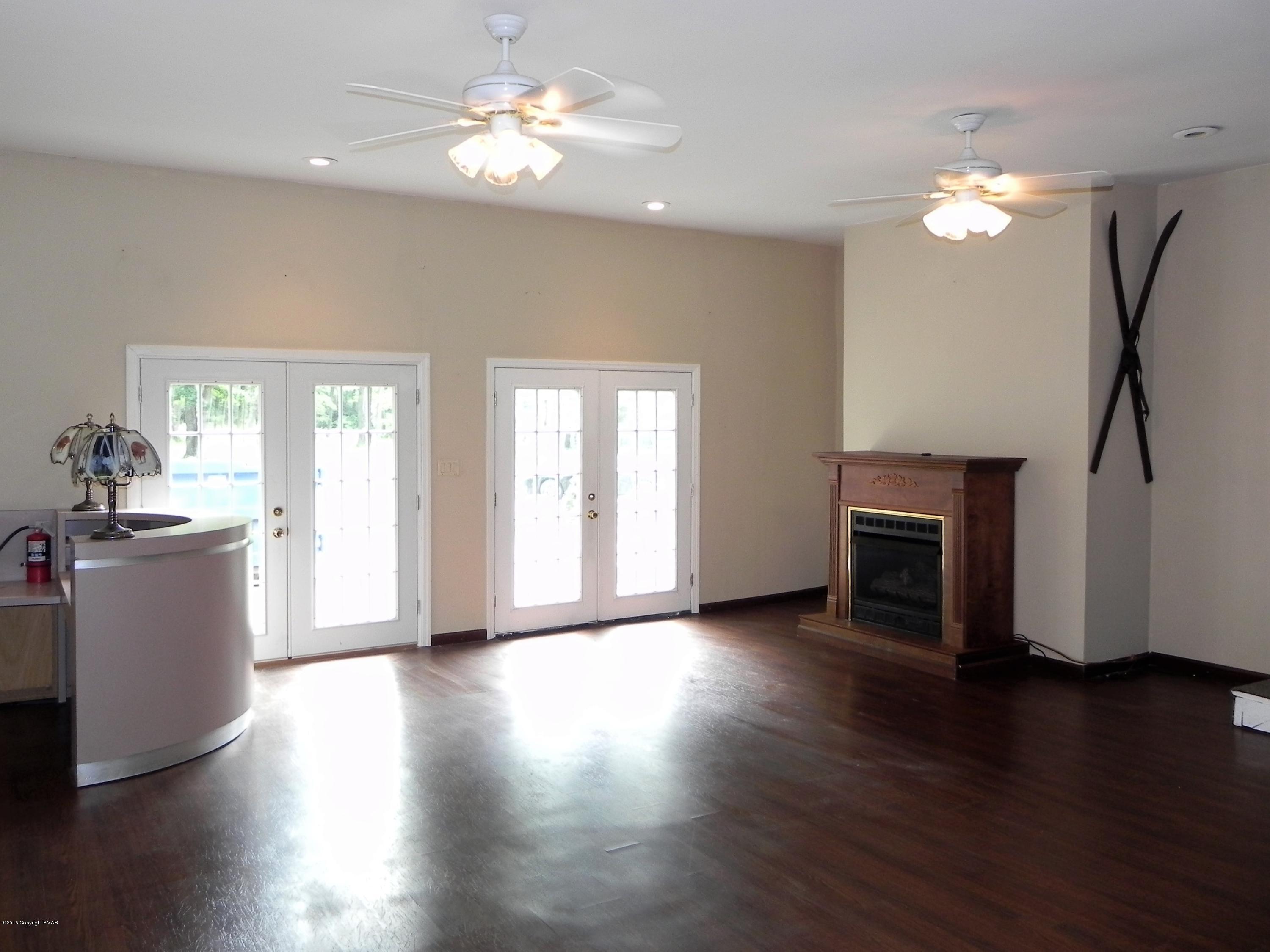 141 Rinker Road Stroudsburg, PA 18360 - Photo 15 of 29 a view of a room with wooden floor and a kitchen